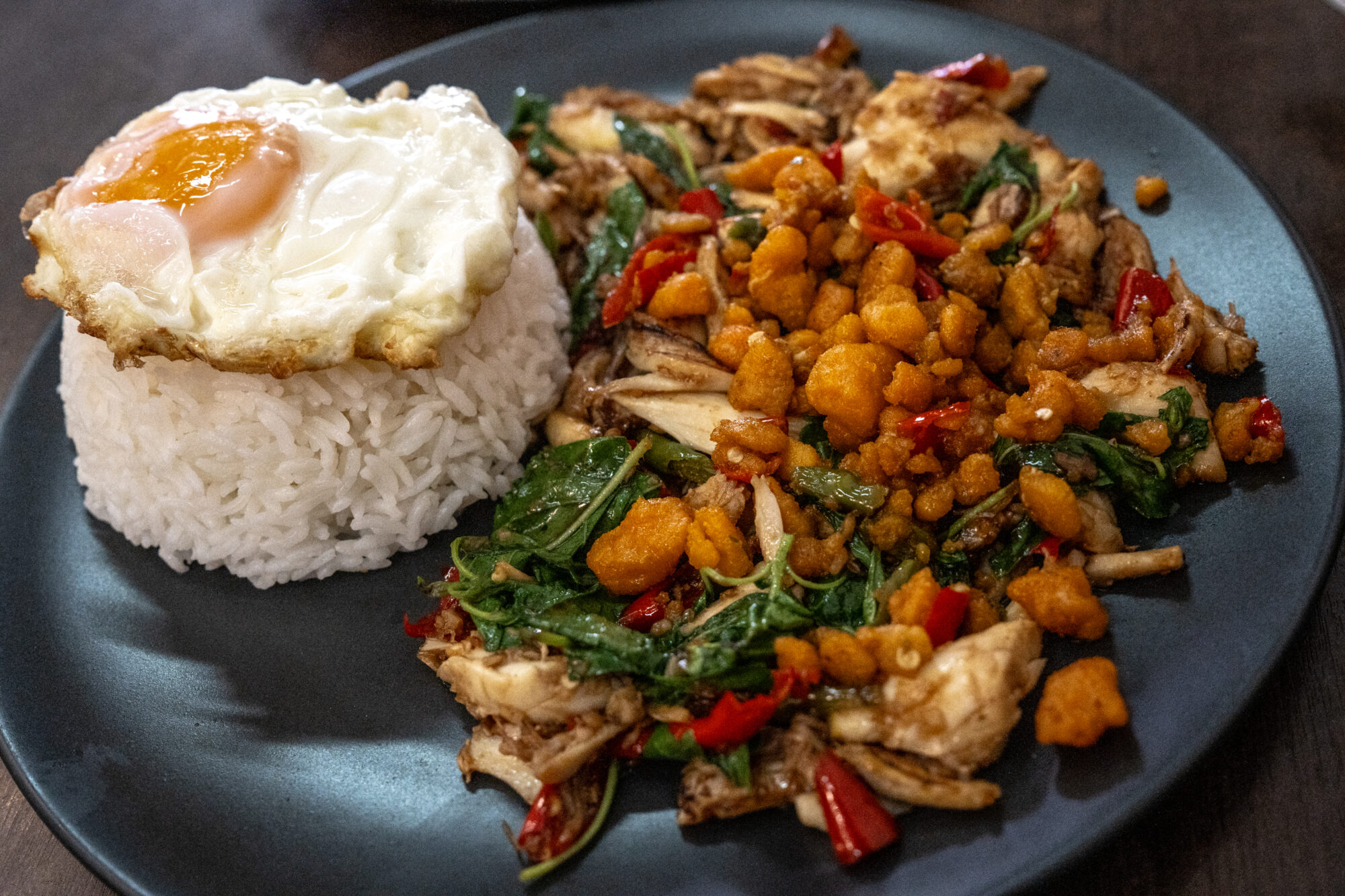 Spicy stir fried crab and basil with rice and fried egg